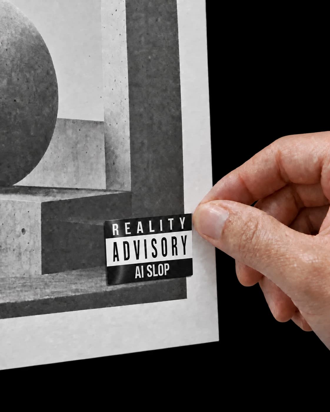 A hand applying an AI Slop sticker to a monochrome printed poster.